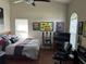Personalized bedroom with wood floors, fan, memorabilia and comfortable bed at 13000 Sandy Pine Ln, Clermont, FL 34711