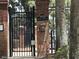 Community gate with brick columns, address plaque, and secure access to Greater Pines Blvd at 13000 Sandy Pine Ln, Clermont, FL 34711