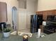 Kitchen featuring matching appliances, lots of cabinet space, and an adjacent door leading to the utility room at 13000 Sandy Pine Ln, Clermont, FL 34711