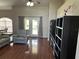 Cozy living room with french doors, featuring hardwood floors, comfortable seating, and stylish built-in shelving at 13000 Sandy Pine Ln, Clermont, FL 34711
