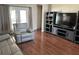 Comfortable living room showcasing a large television, modern shelving, and a plush reclining armchair at 13000 Sandy Pine Ln, Clermont, FL 34711