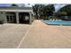 Inviting community pool area with adjacent covered pavilion and well-maintained deck at 13000 Sandy Pine Ln, Clermont, FL 34711