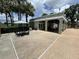 Community pool area with shaded picnic tables, lounge chairs, and easy access to amenities at 13000 Sandy Pine Ln, Clermont, FL 34711