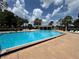 Large community pool with clear water, ample seating, and a poolside pavilion for residents at 13000 Sandy Pine Ln, Clermont, FL 34711