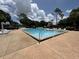 Community swimming pool with comfortable lounge chairs, umbrellas, and plenty of space for relaxation at 13000 Sandy Pine Ln, Clermont, FL 34711