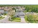 Aerial view of a charming neighborhood showcasing a home with a well-kept lawn and three-car garage at 13691 Crystal River Dr, Orlando, FL 32828
