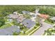 An aerial view shows this home in a neighborhood of similar houses near a pond at 13691 Crystal River Dr, Orlando, FL 32828