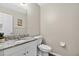 Well-lit half bathroom with granite countertop vanity and neutral wall paint at 13691 Crystal River Dr, Orlando, FL 32828