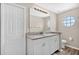Bathroom featuring double sinks with granite countertops, and a round window at 13691 Crystal River Dr, Orlando, FL 32828