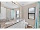 Bathroom featuring double sinks, granite countertops, and a tiled shower at 13691 Crystal River Dr, Orlando, FL 32828