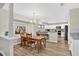 Bright dining area flowing into a modern kitchen with white cabinetry and stainless steel appliances at 13691 Crystal River Dr, Orlando, FL 32828