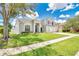 Beautiful two-story home with lush green lawn, mature tree, and brick accents at 13691 Crystal River Dr, Orlando, FL 32828