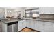 Stylish kitchen with stainless steel appliances, granite countertops, and white cabinetry at 13691 Crystal River Dr, Orlando, FL 32828