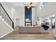 Open-concept living room featuring soaring ceilings, a fireplace, and modern staircase at 13691 Crystal River Dr, Orlando, FL 32828