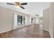 Spacious living room with hardwood floors, ceiling fans, and pool view windows at 13691 Crystal River Dr, Orlando, FL 32828