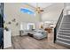Bright, open-concept living room with vaulted ceilings, hardwood floors and a large sectional sofa at 13691 Crystal River Dr, Orlando, FL 32828