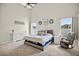 Bright primary bedroom features plush carpet, natural light, and calming decor at 13691 Crystal River Dr, Orlando, FL 32828