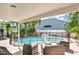 Covered patio view of the backyard swimming pool with safety fence and comfortable outdoor seating area at 13691 Crystal River Dr, Orlando, FL 32828