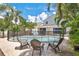 Backyard swimming pool with safety fence surrounded by lush tropical landscaping and outdoor seating at 13691 Crystal River Dr, Orlando, FL 32828