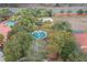 Aerial view showcasing the community's fountain, playground, and recreation areas amid lush landscaping at 1428 Solana Cir, Davenport, FL 33897