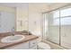 Functional bathroom with a shower-tub combo, neutral counter tops and vanity with ample lighting at 1428 Solana Cir, Davenport, FL 33897
