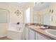 Bright bathroom featuring a large soaking tub and a double vanity at 1428 Solana Cir, Davenport, FL 33897