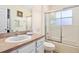 Bright bathroom with a shower-tub combo, neutral counter tops and vanity with ample lighting at 1428 Solana Cir, Davenport, FL 33897