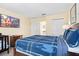 Bright bedroom featuring a wooden bed frame, mounted TV, and ample space for a Bedroom at 1428 Solana Cir, Davenport, FL 33897