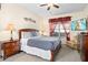 Well-lit bedroom showcases a comfortable bed with decorative pillows and warm lighting at 1428 Solana Cir, Davenport, FL 33897