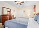 Spacious bedroom with dark wood furniture, including a large dresser and bedside tables at 1428 Solana Cir, Davenport, FL 33897