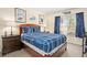 Charming bedroom featuring blue bedding, a wooden bed frame, and serene decor for a peaceful sanctuary at 1428 Solana Cir, Davenport, FL 33897