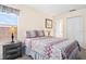 Well-lit bedroom with a window view, stylish bedding, bedside lamps, and ample closet space at 1428 Solana Cir, Davenport, FL 33897