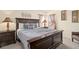 Comfortable bedroom featuring a wood bed frame, stylish lamps, and neutral decor for a relaxing ambiance at 1428 Solana Cir, Davenport, FL 33897