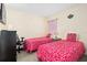 Bright bedroom featuring two twin beds, soft natural light, and comfortable furnishings at 1428 Solana Cir, Davenport, FL 33897
