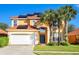 Inviting two-story home featuring an attached two car garage, solar panels and a red tiled roof at 1428 Solana Cir, Davenport, FL 33897