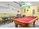 Spacious garage featuring a pool table and ping pong table, perfect for games and Gathering entertainment at 1428 Solana Cir, Davenport, FL 33897
