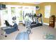 Well-equipped gym with treadmills, stationary bikes, and natural light, encouraging a healthy lifestyle at 1428 Solana Cir, Davenport, FL 33897