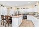 Bright kitchen with an island, stainless steel appliances, and an adjacent dining area for casual meals at 1428 Solana Cir, Davenport, FL 33897