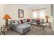Comfortable living room with stylish decor, featuring a large sectional sofa, side tables, and a serene atmosphere at 1428 Solana Cir, Davenport, FL 33897