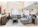 Bright living room with tall ceilings and stylish furniture is connected to the kitchen area at 1428 Solana Cir, Davenport, FL 33897
