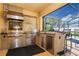 This outdoor kitchen is equipped with a grill, counter space, stainless steel drawers, and a vent hood at 1428 Solana Cir, Davenport, FL 33897