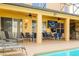 Relaxing patio featuring lounge chairs, dining sets, and an outdoor television, perfect for entertaining guests at 1428 Solana Cir, Davenport, FL 33897