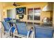 Cozy patio featuring a granite countertop bar, an outdoor television, and comfortable seating at 1428 Solana Cir, Davenport, FL 33897