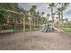 Community playground area with swings and play structure, offering a safe and engaging space for children at 1428 Solana Cir, Davenport, FL 33897