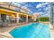 The screened pool area with safety fence and outdoor seating is perfect for relaxing and enjoying the Florida sunshine at 1428 Solana Cir, Davenport, FL 33897