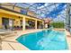 A screened in pool with an outdoor dining and lounging area offering space for relaxation and entertainment at 1428 Solana Cir, Davenport, FL 33897
