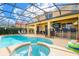 Relax in this screened pool and hot tub oasis, complete with an outdoor entertainment area at 1428 Solana Cir, Davenport, FL 33897