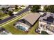 Aerial view showcases the private pool, screened enclosure, lush landscaping, and neighborhood at 150 Barefoot Beach Way, Kissimmee, FL 34746