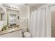 Bathroom featuring granite countertops, white cabinets, shower, toilet, and sink at 150 Barefoot Beach Way, Kissimmee, FL 34746