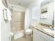 Bathroom with a tiled shower, granite vanity, and coordinated white fixtures at 150 Barefoot Beach Way, Kissimmee, FL 34746